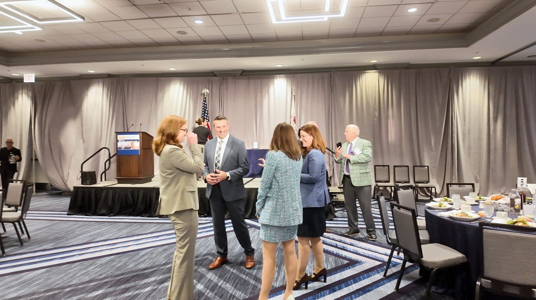 Guests gather near the stage before the program begins.