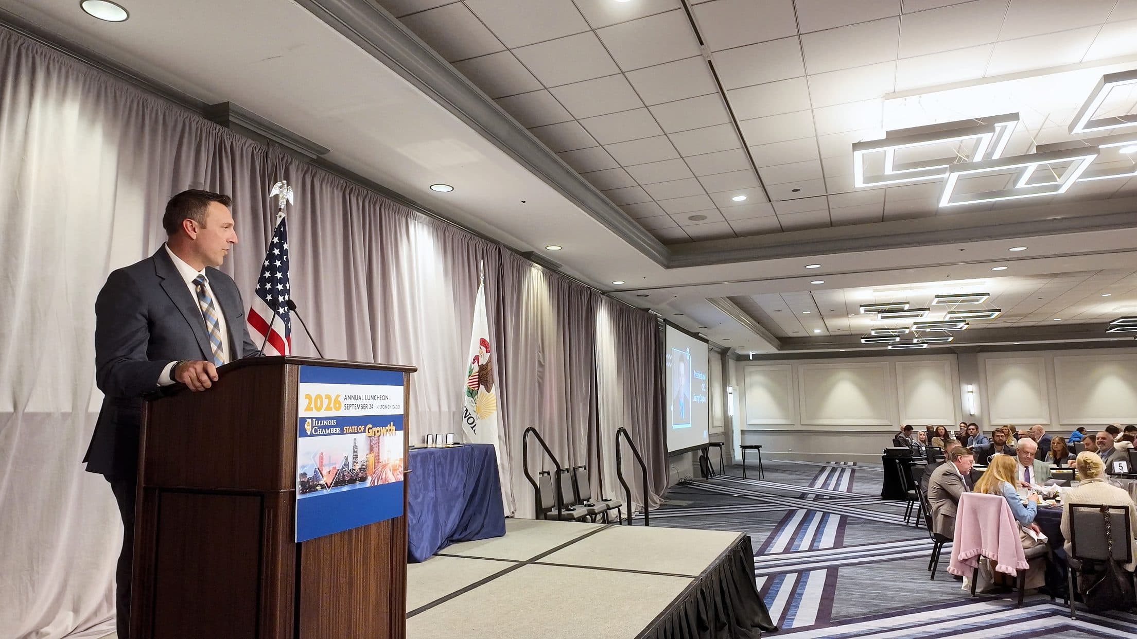 A speaker addresses the ballroom from the podium.